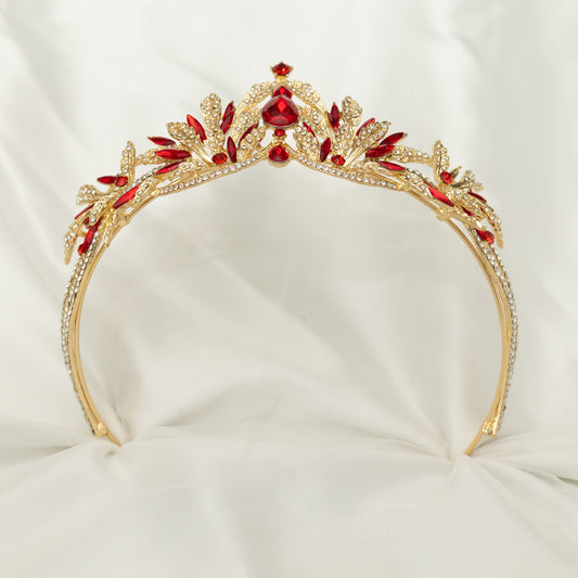 A golden tiara with red crystal embellishments and leaf detailing, displayed against a white background. - Bottom View