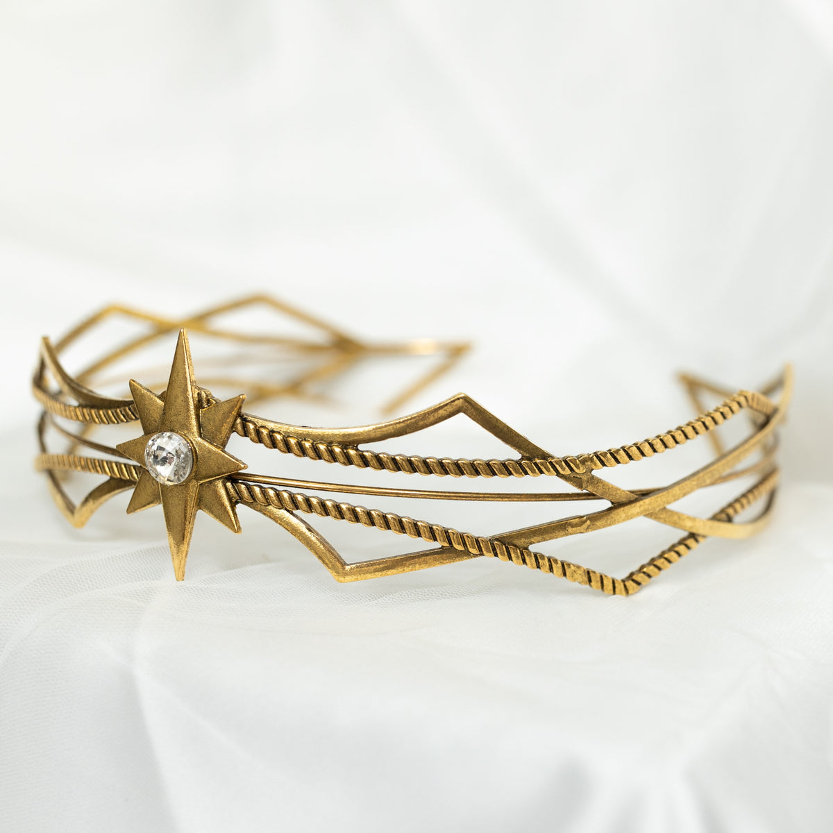 Gold headpiece with star design on a white background
