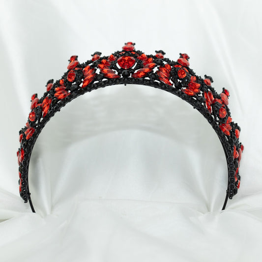 Black tiara with red stones on a white background