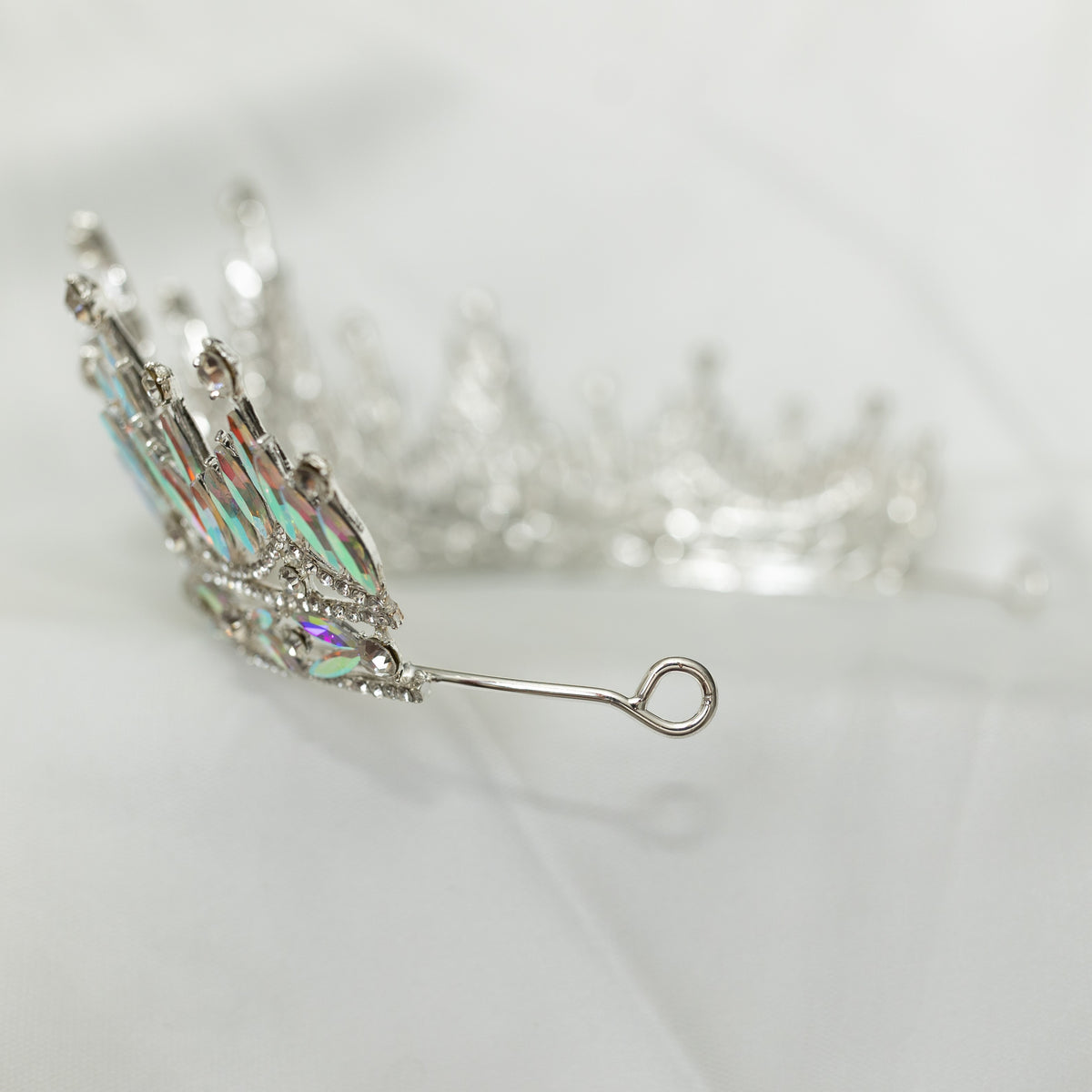 Silver tiara with intricate design on a light background