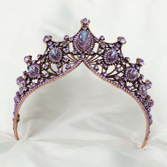 Purple tiara with rhinestones on a white cushion