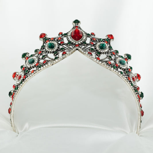 Jeweled tiara with red and green stones on a white background