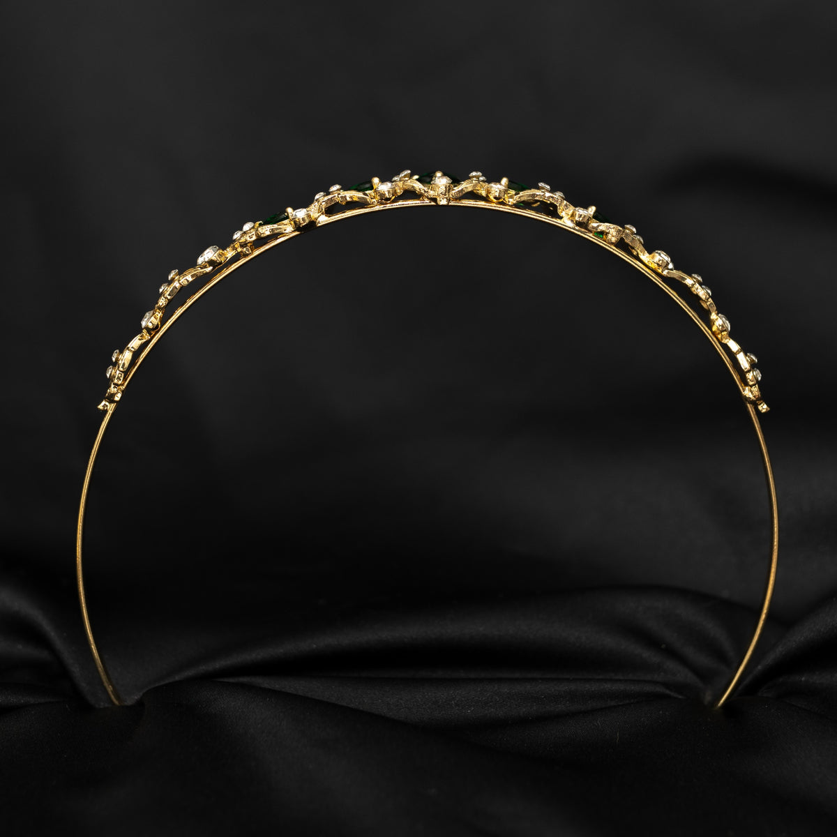 Gold headband with small embellishments on a black background