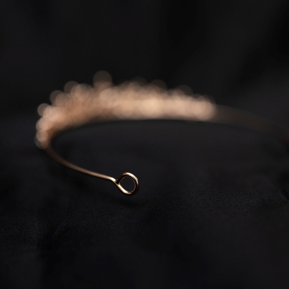 rose gold pink tiara featuring small round clear crystals forming 5 pointed star flower shapes - looped end view