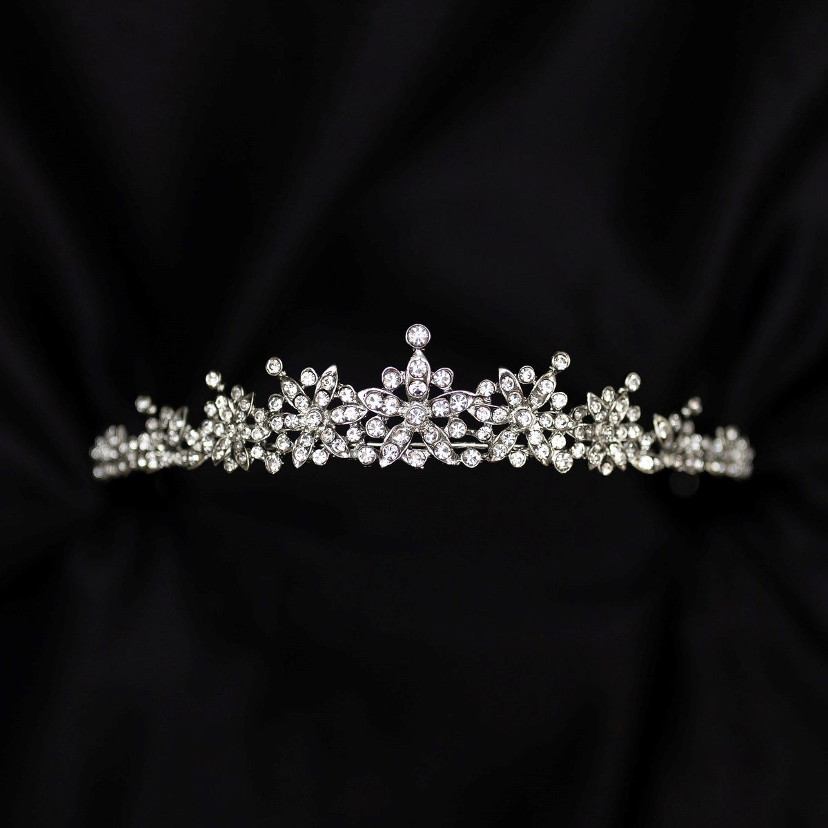 Silver tiara on black background - small crystals with silver metal details in triangular shape - Front view