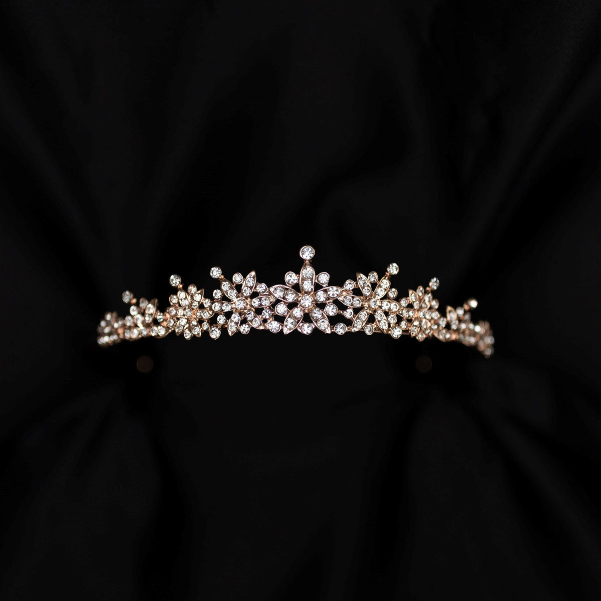 rose gold pink tiara featuring small round clear crystals forming 5 pointed star flower shapes - front view