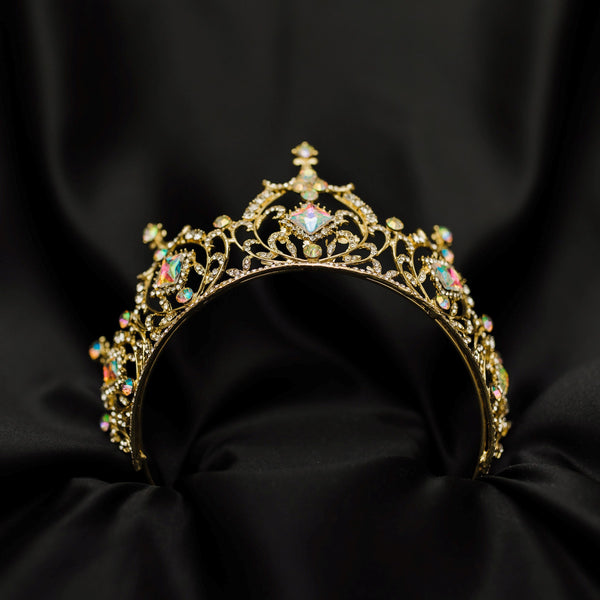 Gold tiara with opal glass crystal gemstones on a black fabric background_ Bottom