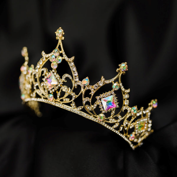 Gold tiara with opal glass crystal gemstones on a black fabric background_ Front Angle
