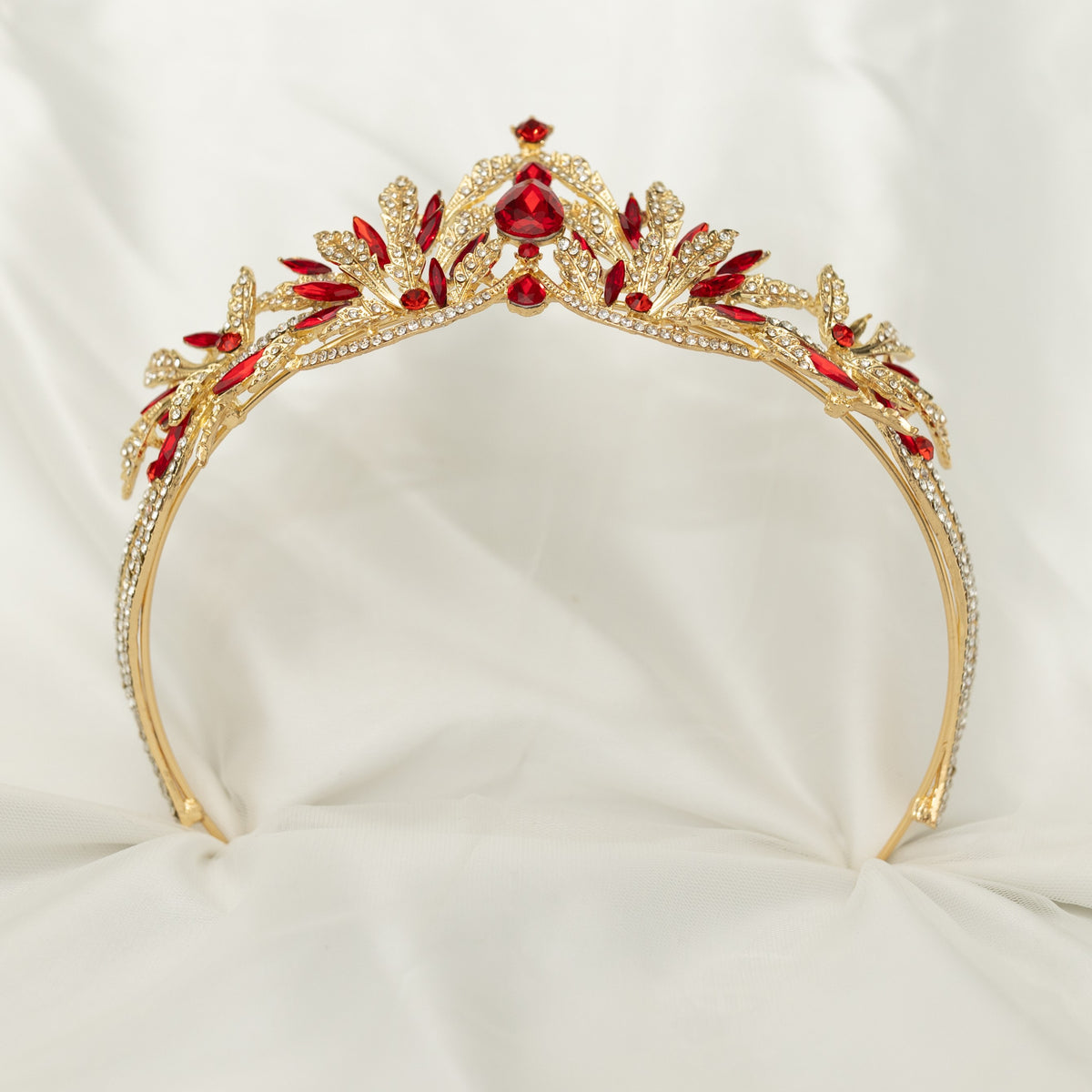 A golden tiara with red crystal embellishments and leaf detailing, displayed against a white background. - Bottom View 