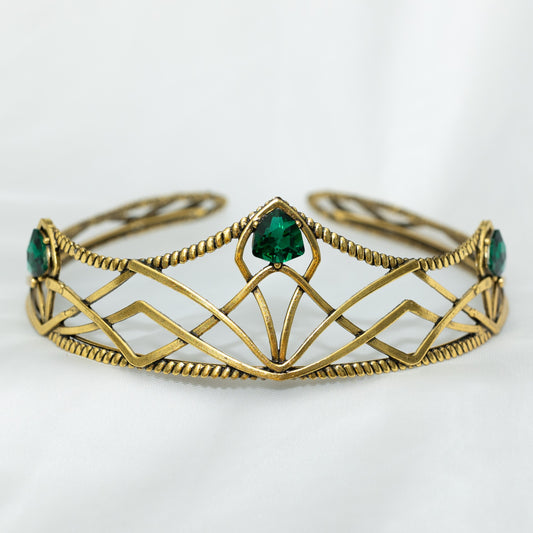emerald crystal three point green gem on gold crown with curving designs and detailed edges - Front View 