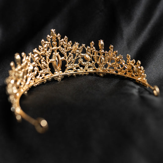 Felicity's Tiara in Light Blue & Gold - A light blue and gold tiara with floral patterns and aqua aquamarine turquoise crystals set in gold-colored metal, displayed against a black background - Rear View 