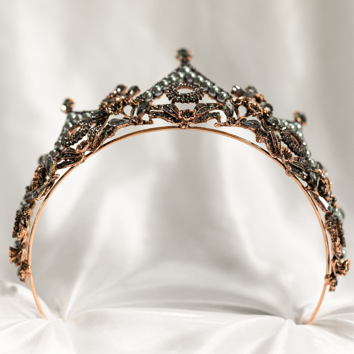 Decorative tiara with intricate design on a white background