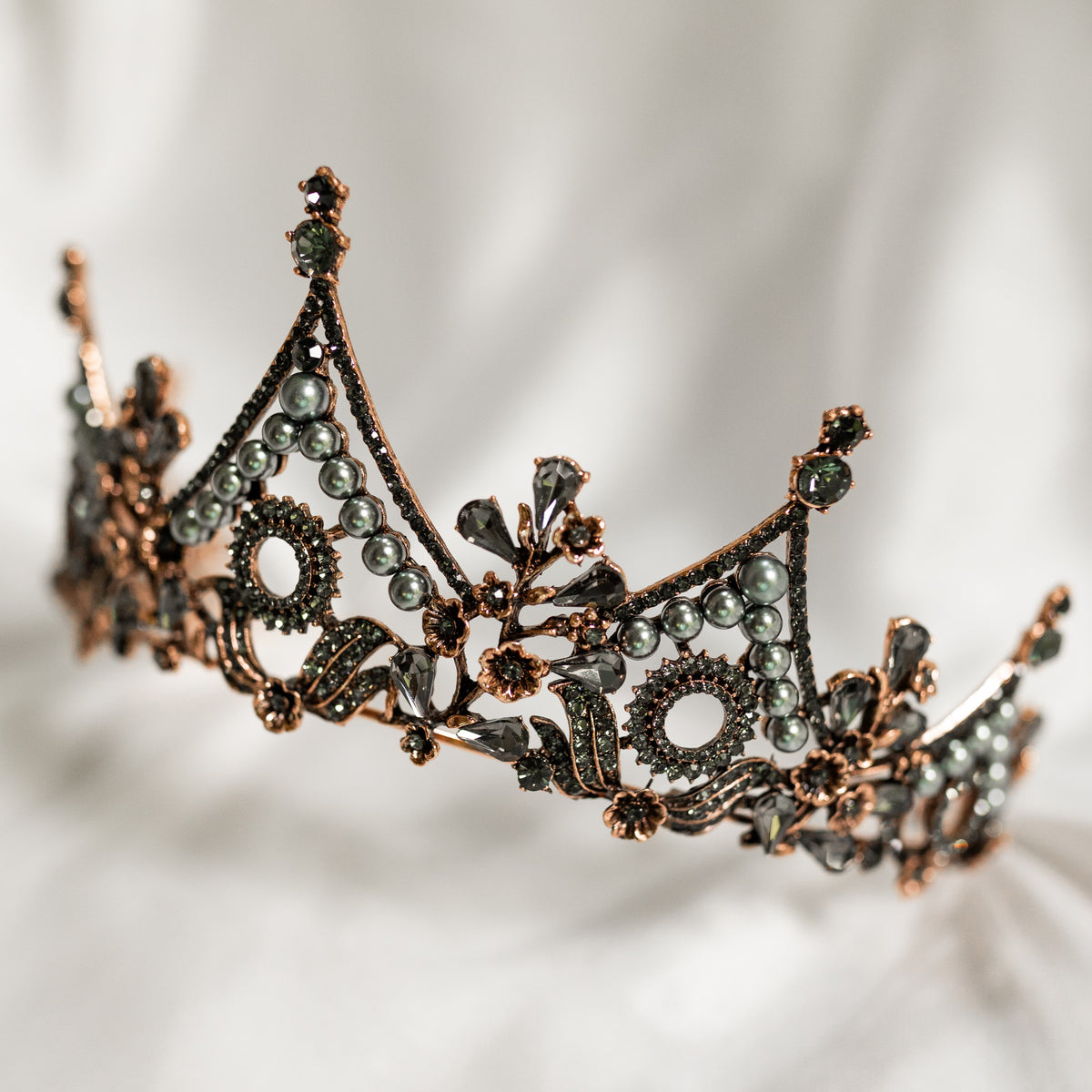 Decorative tiara with intricate design on a soft gray background