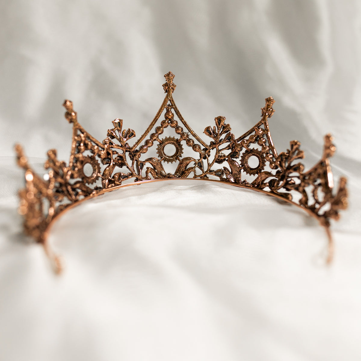 Bronze tiara on a white fabric background