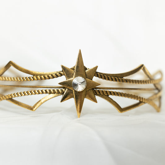 Gold headpiece with star design on a white background