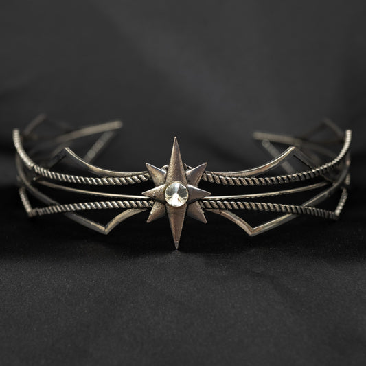 Silver star-shaped headpiece on a black background w/ central clear crystal - Front View 