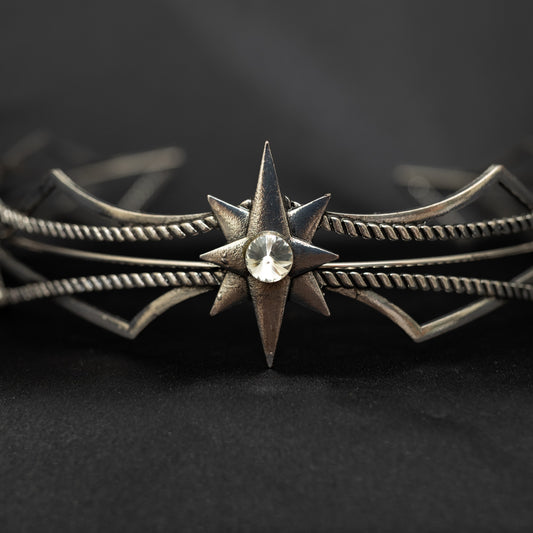 Silver star-shaped headpiece on a black background w/ central clear crystal - Closeup Front View