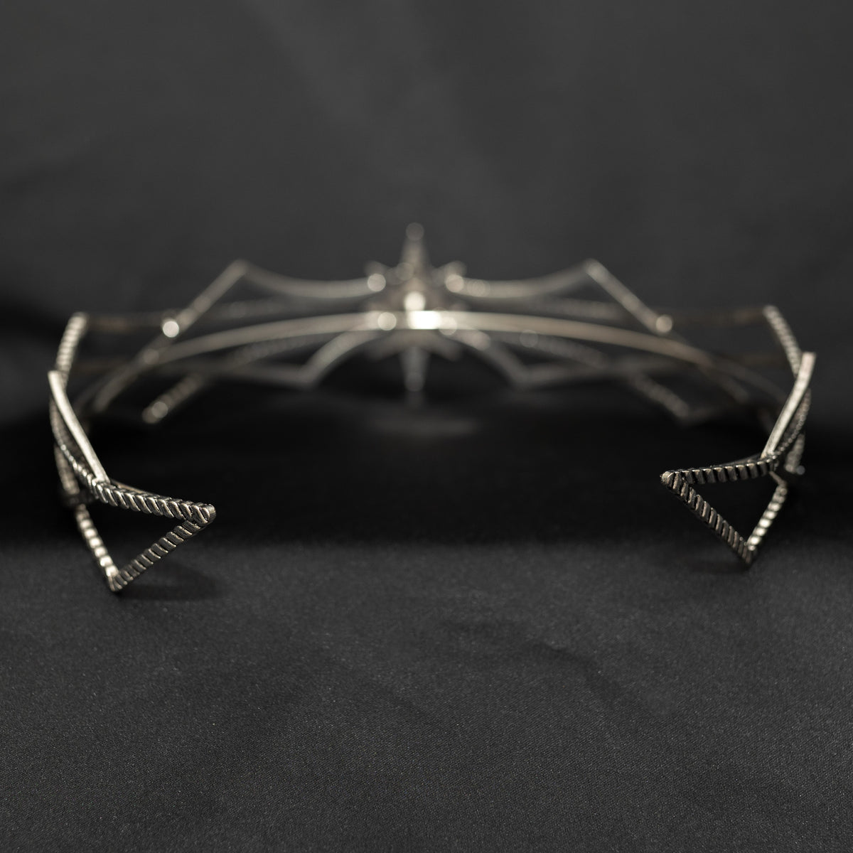 Silver star-shaped headpiece on a black background w/ central clear crystal - Rear View 