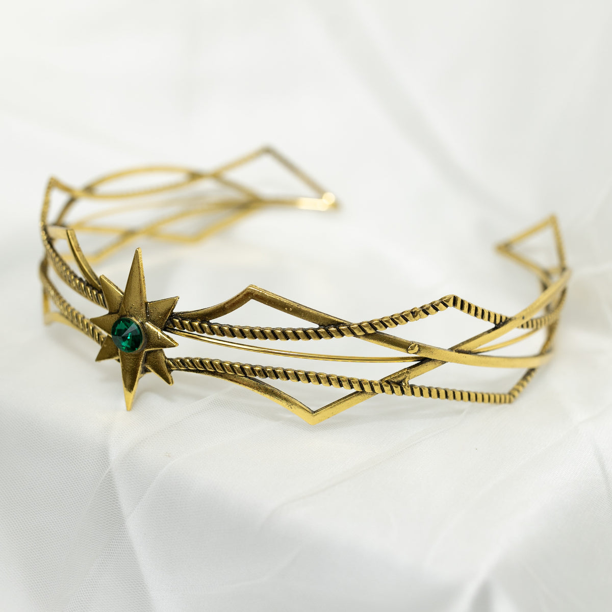 Gold bracelet with star design on a white background