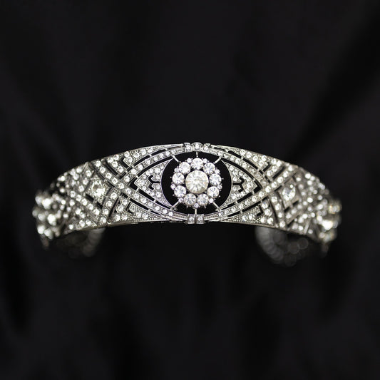 A silver-colored metal tiara with clear crystals set around the circumference, featuring a central decorative front - Front View 