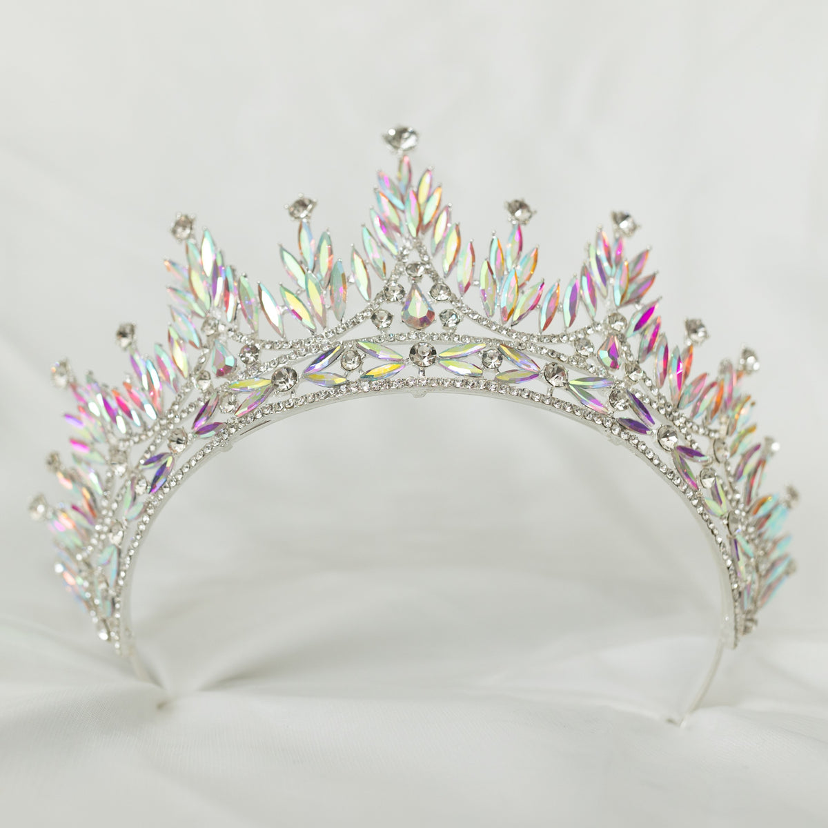 Silver tiara with colorful gemstones on a white background