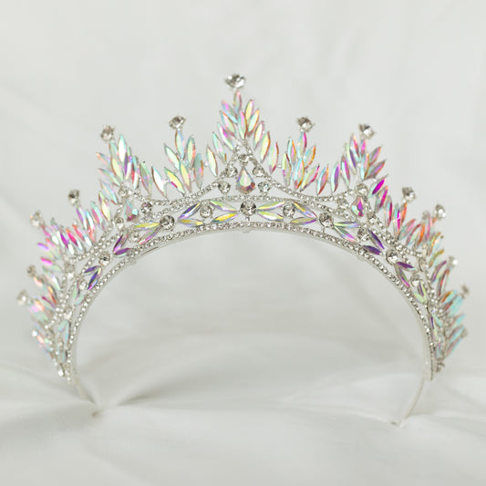 Silver tiara with colorful gemstones on a white background