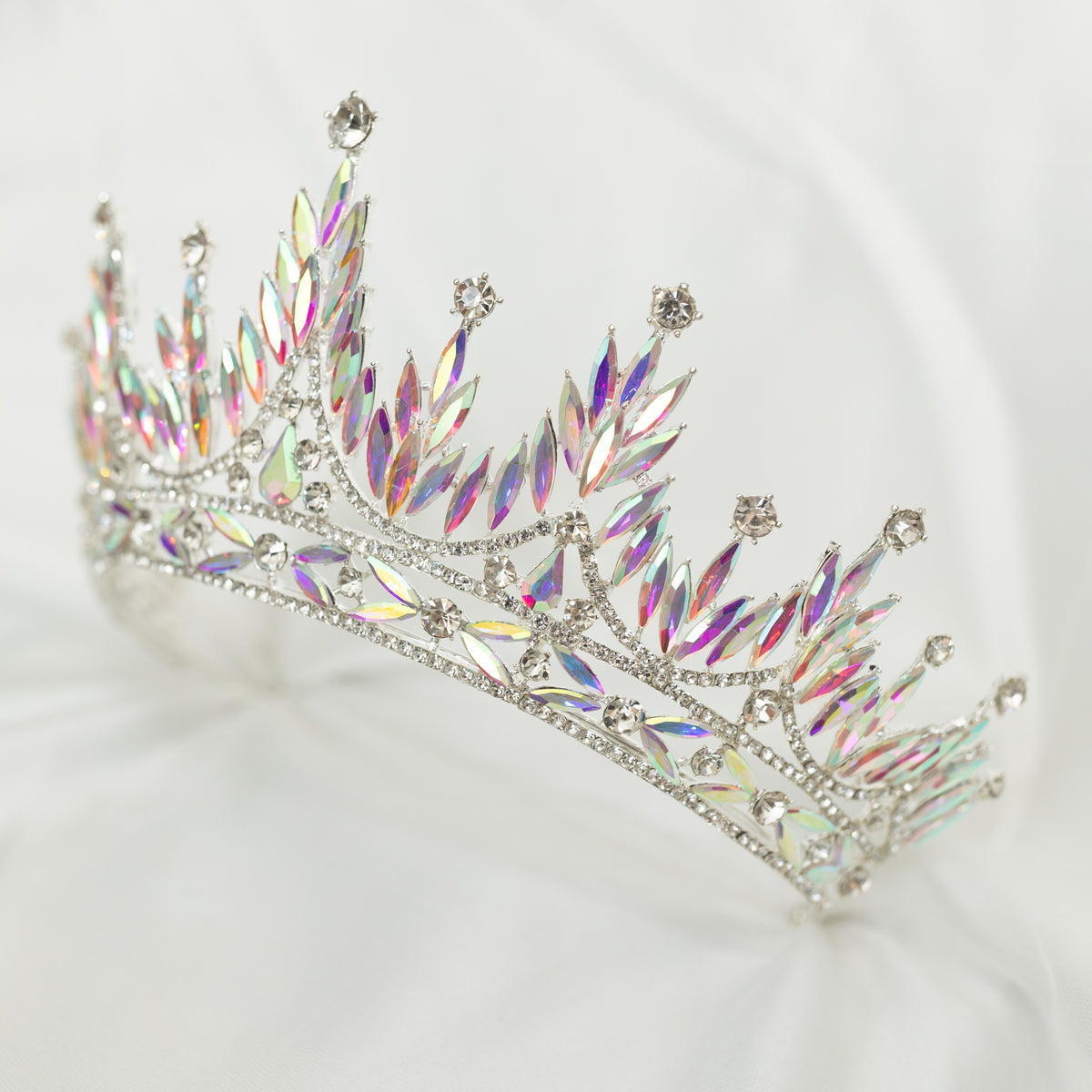 Sparkling tiara with iridescent stones on a white background