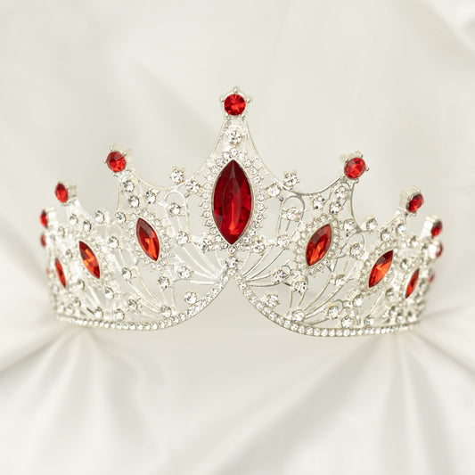 Silver tiara with red gemstones on a white background
