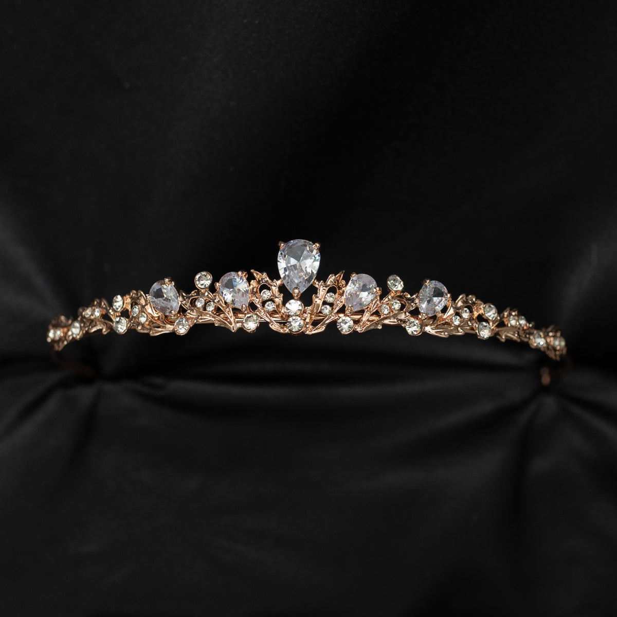 Rose gold tiara with crystals on a black background
