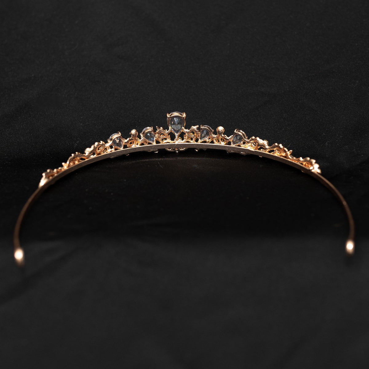 Gold tiara with small diamonds on a black background