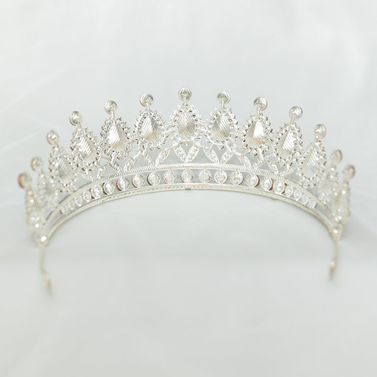 Silver tiara on a light gray background