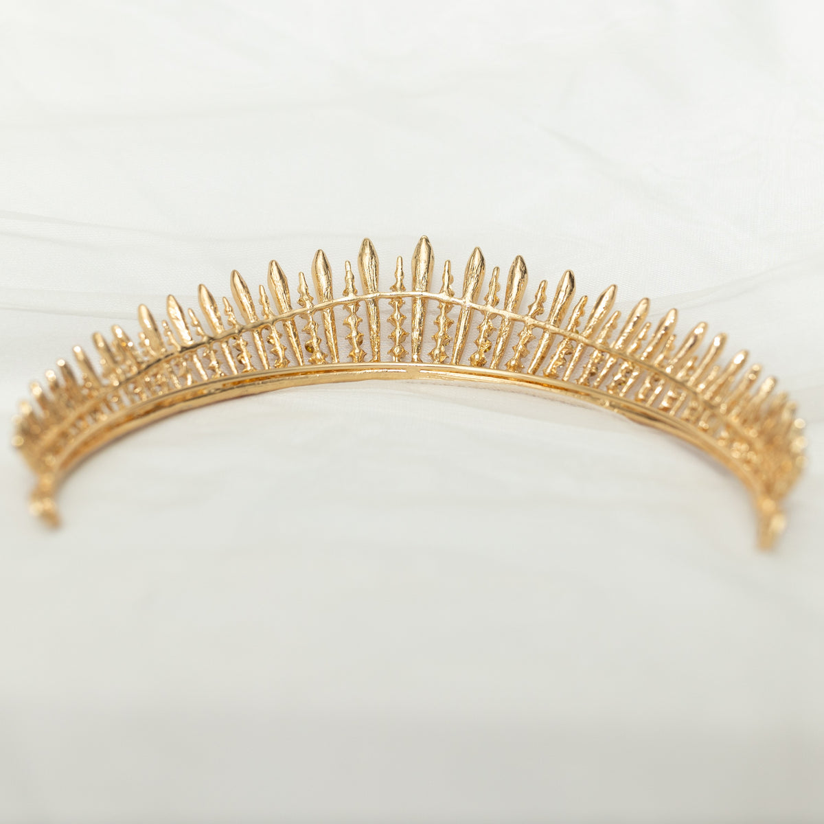 A pink and gold tiara with a spire design, featuring clear crystals.  Rear view 