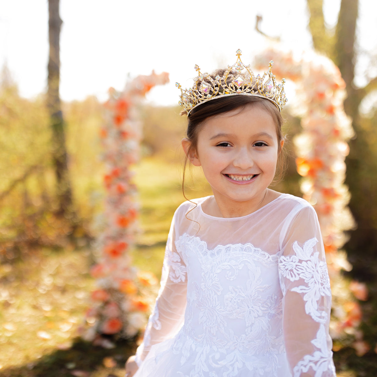 Gold tiara with opal glass crystal gemstones on a black fabric background_ Modeled
