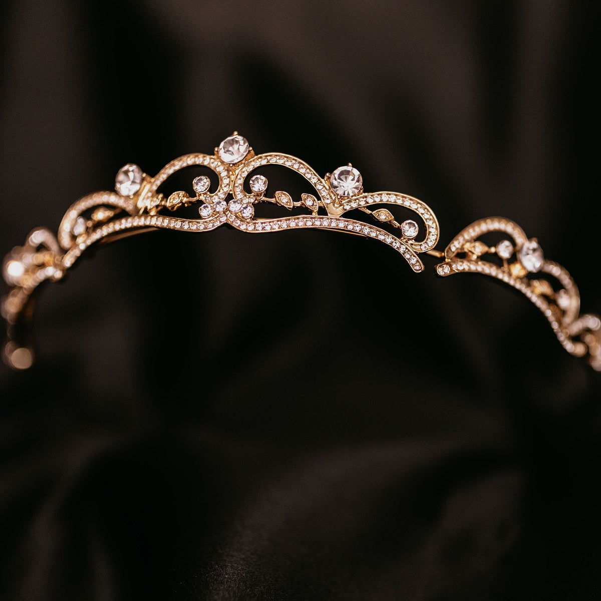 Elegant minimalist gold tiara with delicate crystal accents and classic curved design - Front Angle VIew