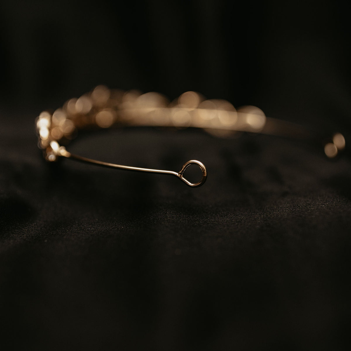 Elegant minimalist gold tiara with delicate crystal accents and classic curved design - Looped End View 