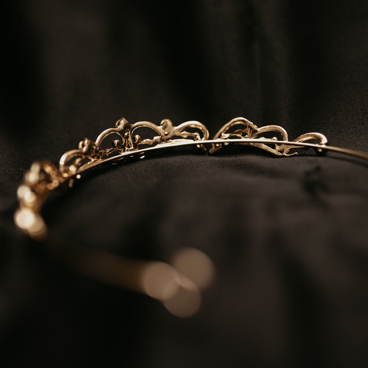 Elegant minimalist gold tiara with delicate crystal accents and classic curved design -  Back View 