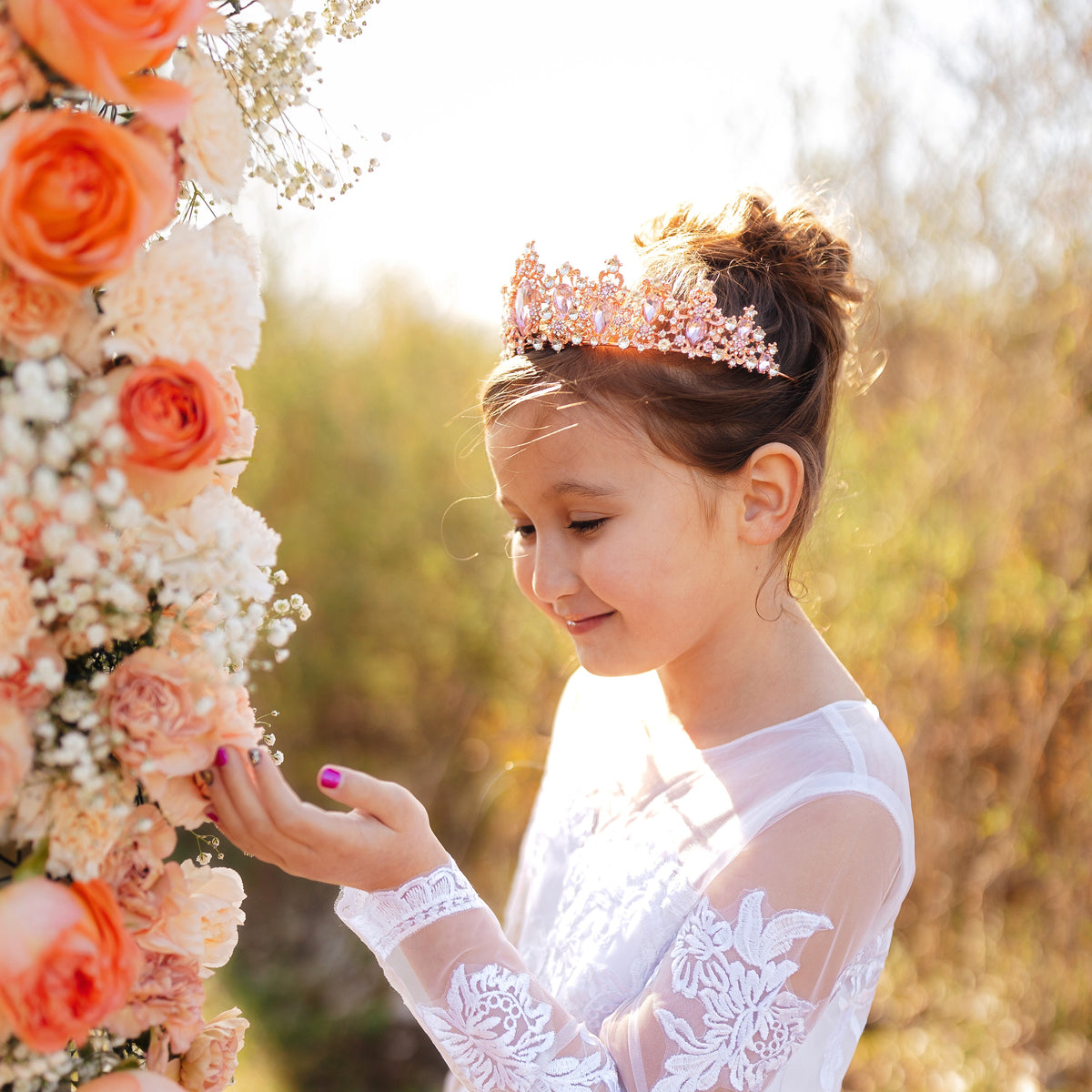 Modeled Michelle's Tiara in Pink - Little girl wearing large tiara with pink tear drop stones with small round stones throughout set in rose gold color metal 