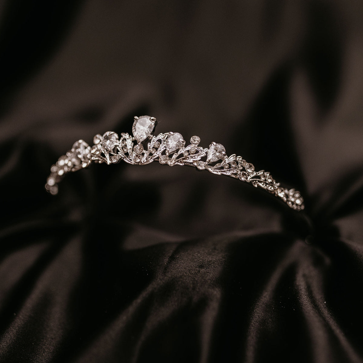 Sadie's Tiara - Petite Small Silver Tiara with Clear Crystals - One larger main crystal tear drop shape and two more tear drop shape crystals on either side, many small clear crystals throughout with leaf and vine metal detailing - Front Angle View 