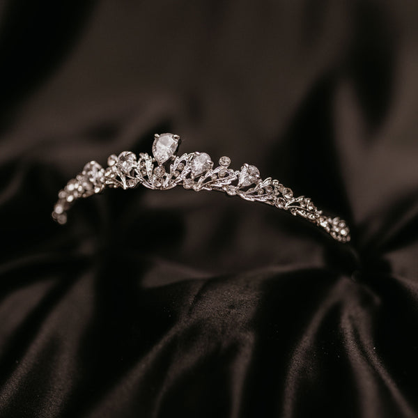 Sadie's Tiara - Petite Small Silver Tiara with Clear Crystals - One larger main crystal tear drop shape and two more tear drop shape crystals on either side, many small clear crystals throughout with leaf and vine metal detailing - Front Angle View 