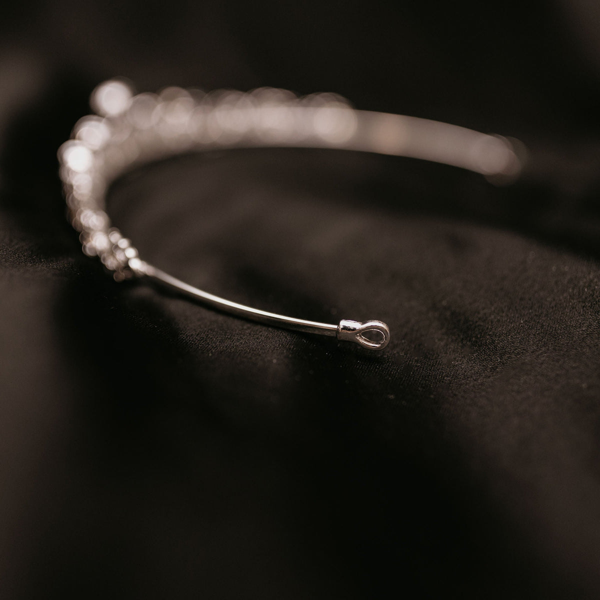 Sadie's Tiara - Petite Small Silver Tiara with Clear Crystals - One larger main crystal tear drop shape and two more tear drop shape crystals on either side, many small clear crystals throughout with leaf and vine metal detailing - Looped End View 
