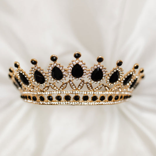 Saya’s tiara in black and gold with black teardrop crystals, clear rhinestones, and ornate gold detailing - front