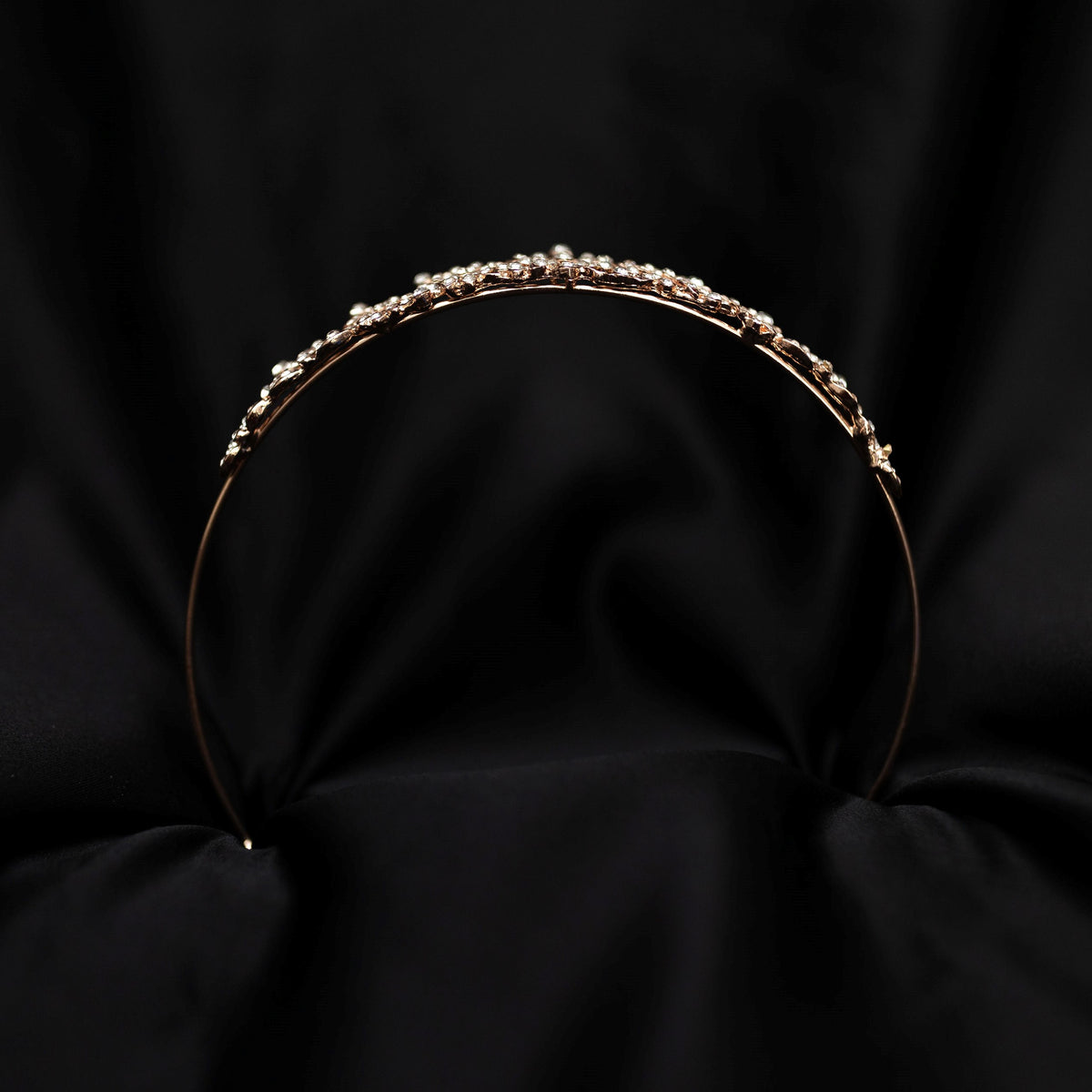 rose gold pink tiara featuring small round clear crystals forming 5 pointed star flower shapes - bottom view
