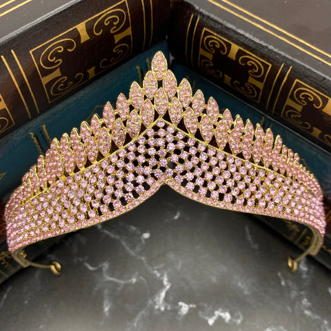 Paola's tiara in pink color crystals, yellow gold color metal, dozens of tiny crystals forming a design of medium size dots to work a single peak center - Front