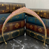 Paola's tiara in pink color crystals, yellow gold color metal, dozens of tiny crystals forming a design of medium size dots to work a single peak center - Bottom View