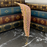 Paola's tiara in pink color crystals, yellow gold color metal, dozens of tiny crystals forming a design of medium size dots to work a single peak center - Side View